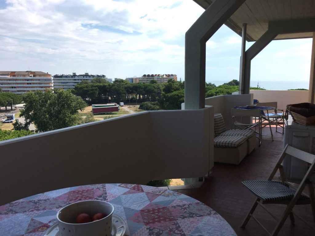 圣玛格丽塔波尔勒港Apartments in Porto Santa Margherita 42872的阳台配有一张桌子,上面放着一碗水果