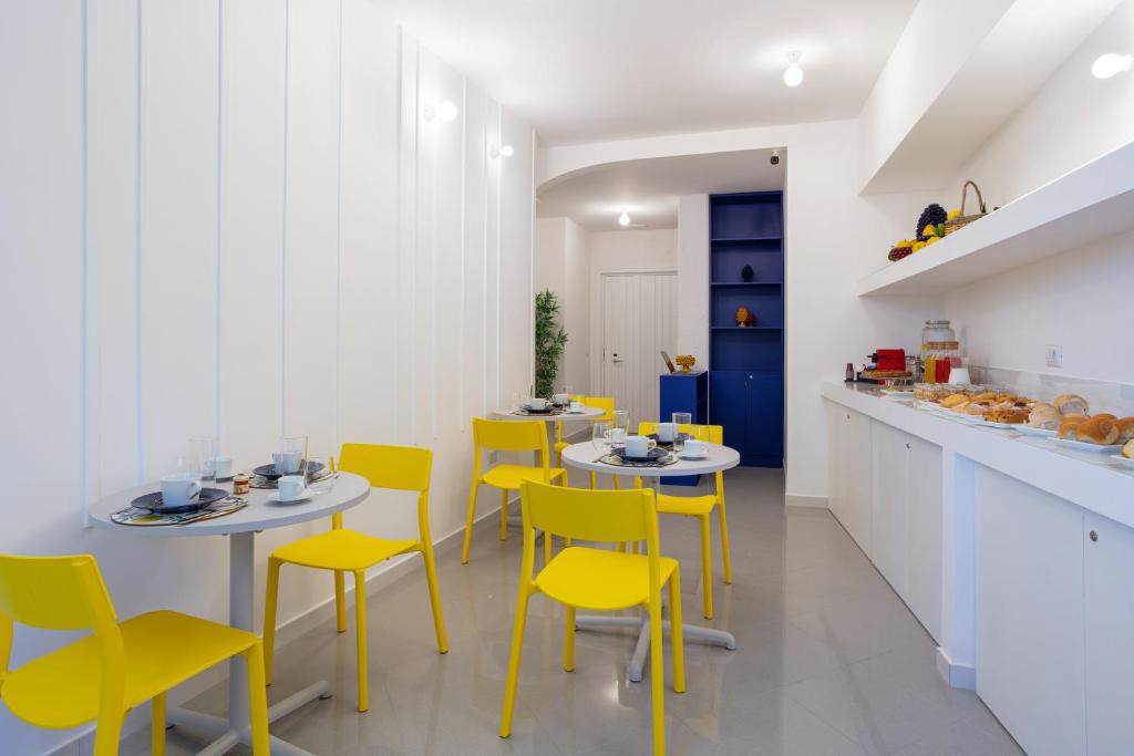 皮雅诺迪索伦托Nesea的厨房配有黄色的椅子、桌子和柜台