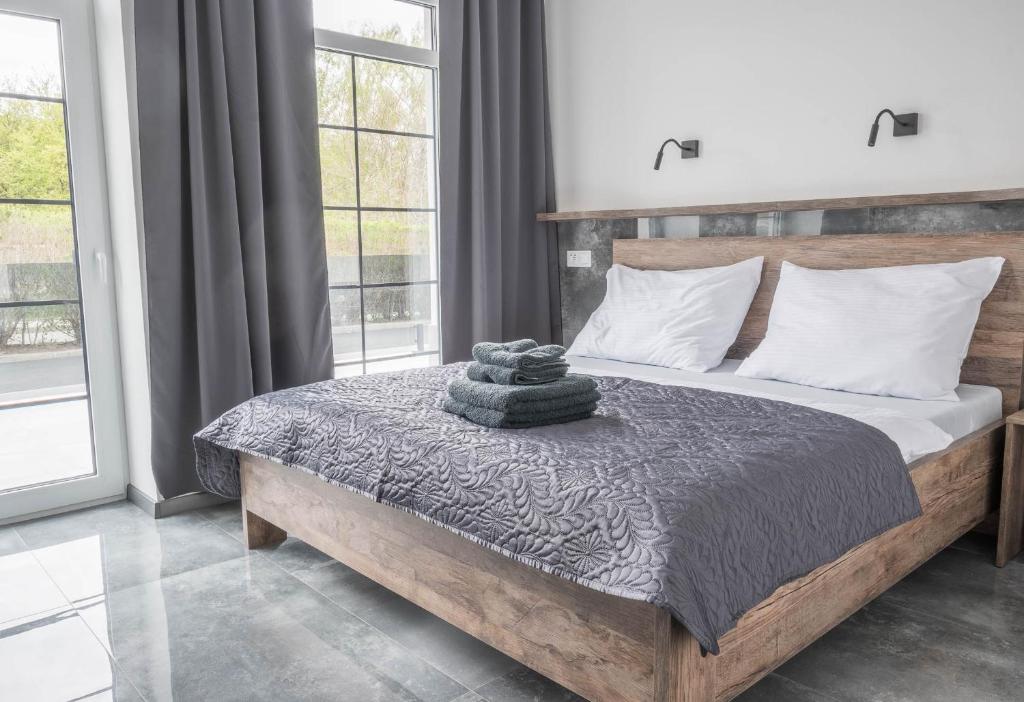 瓦尔季采Veltlin Bed & Wine的一间卧室配有一张带木制床头板和窗户的床。