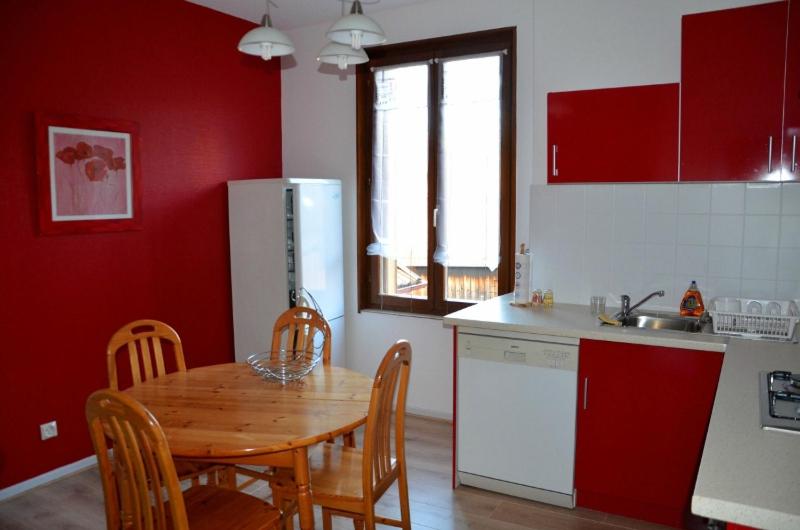 Luttenbach-près-MunsterChez Laurence et Claude - Vallée de Munster的一间带木桌的厨房和一间带红色墙壁的厨房