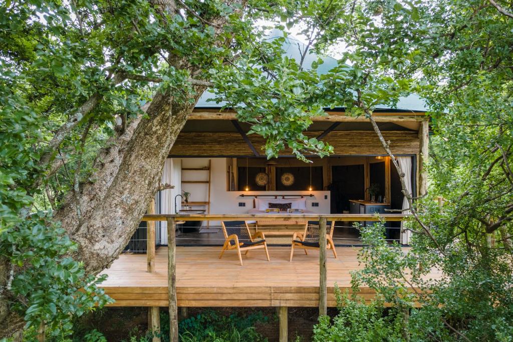 伯格维尔Sasi Africa Luxury Tented Bush Lodge的房屋设有带桌椅的木制甲板