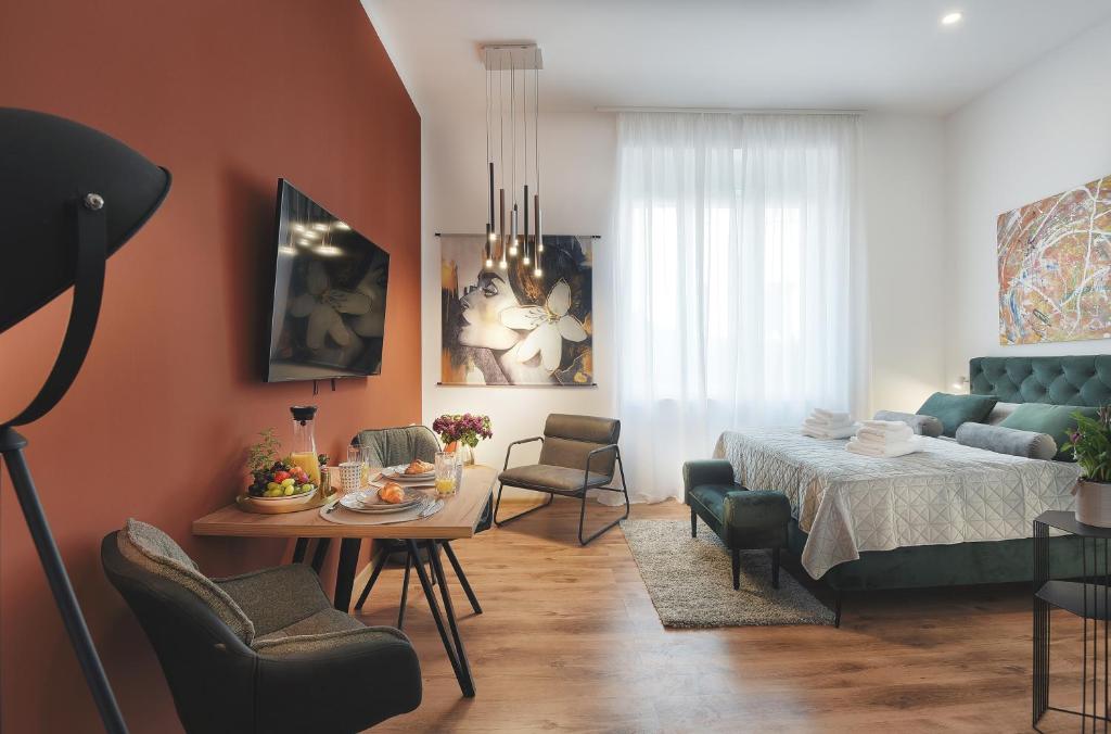 普拉Emi Luxury Apartments的客厅配有床和桌椅