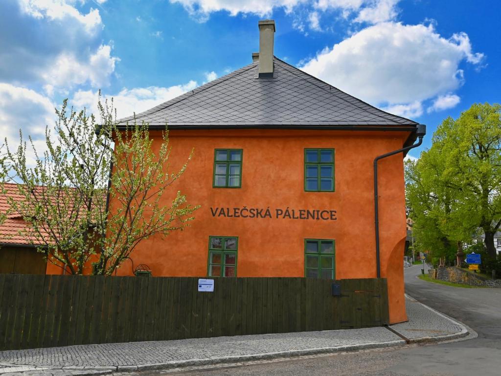 ValečValečská pálenice的一座橙色的建筑,上面写着“华丽的宫殿”