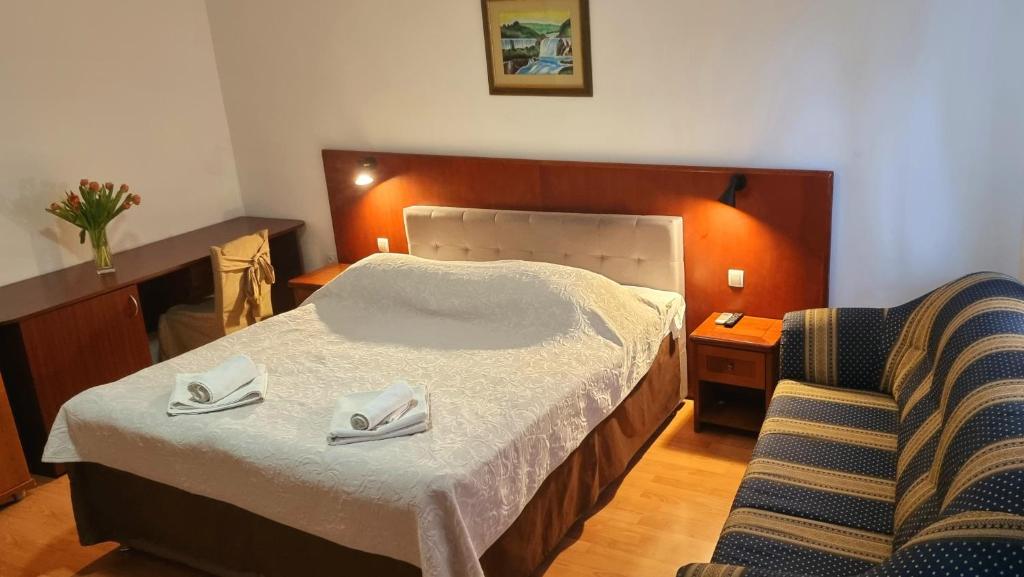 斯克拉丁Restaurant & rooms Visovac - best value的配有一张床和一把椅子的酒店客房
