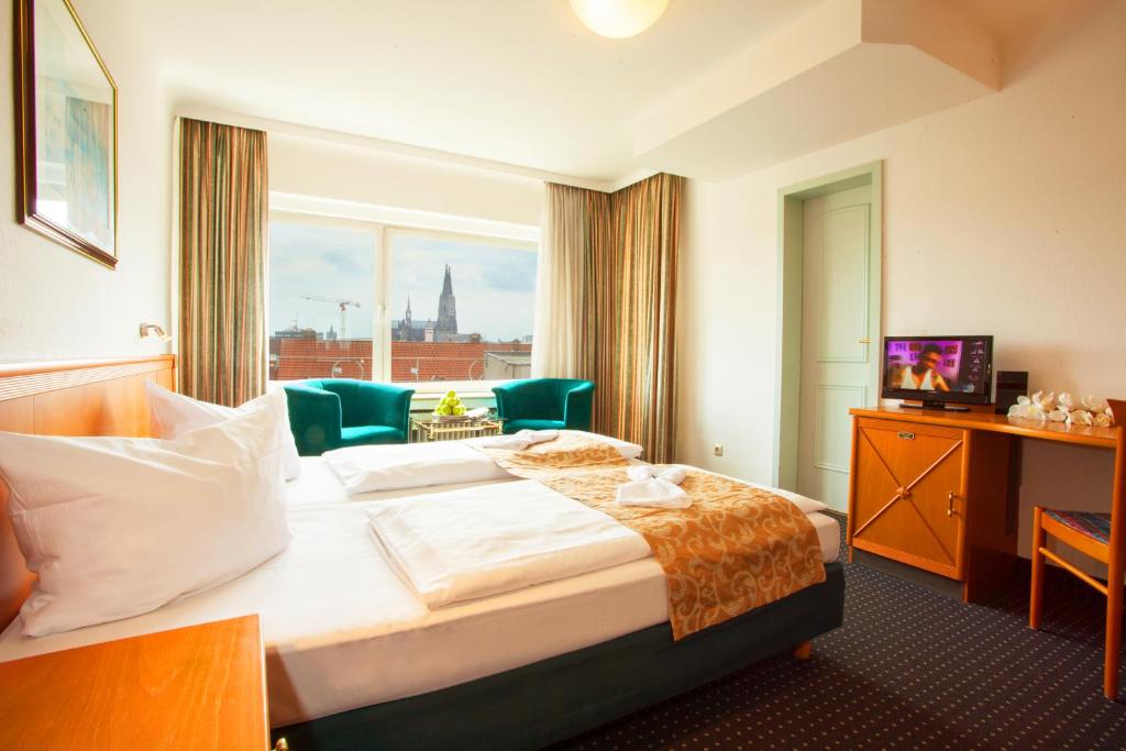 科隆皇家中心酒店的一间设有大床和窗户的酒店客房