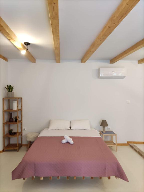 Ágios RókkosZaira's Apartment Corfu Town的一间卧室配有一张大床和紫色毯子