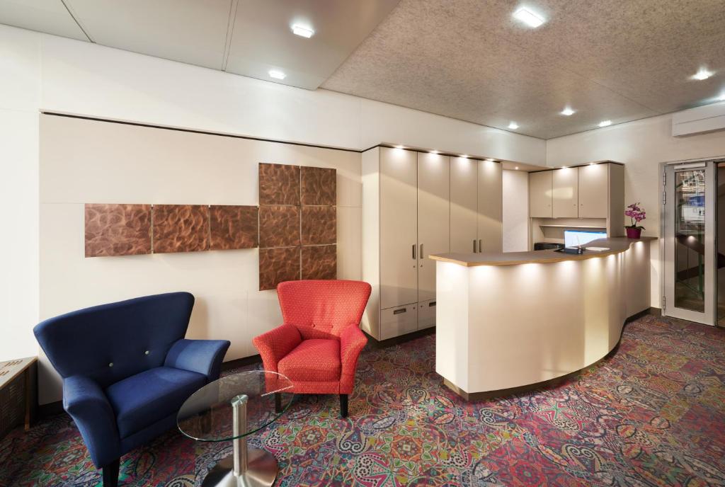 斯图加特万森斯塔德酒店的一间设有两把椅子和一张桌子的等候室