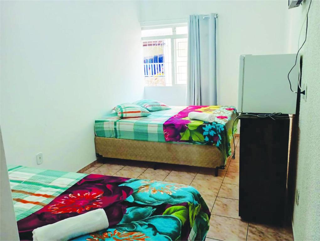 阿帕雷西达Pousada Jesus Misericordioso的一间卧室设有两张床和窗户。