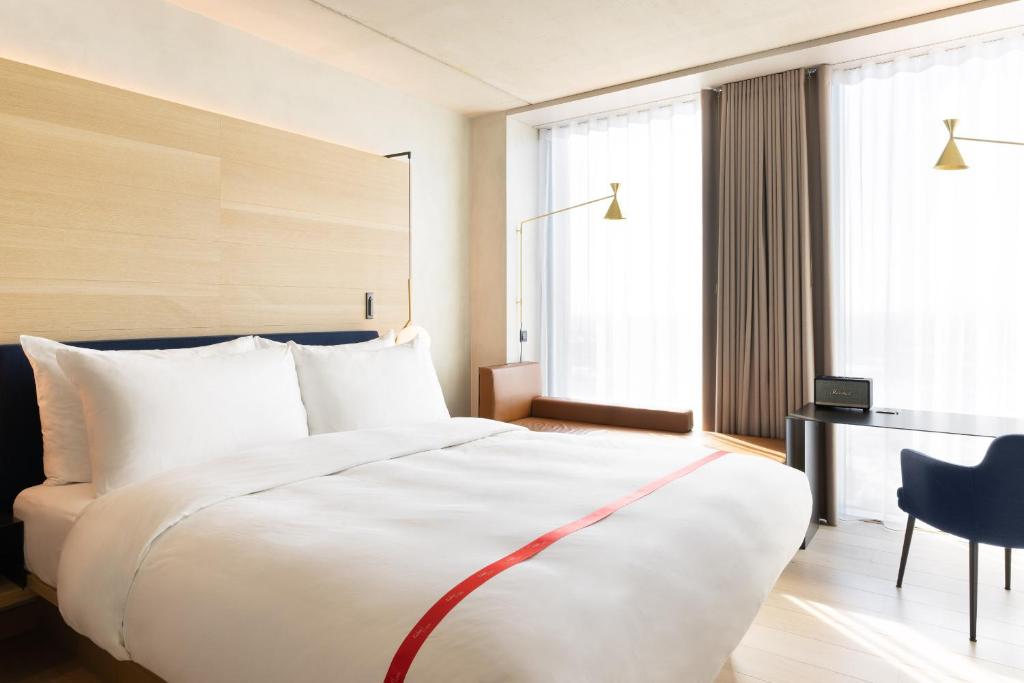 阿姆斯特丹Ruby Emma Hotel Amsterdam的酒店客房设有一张白色大床和一张书桌