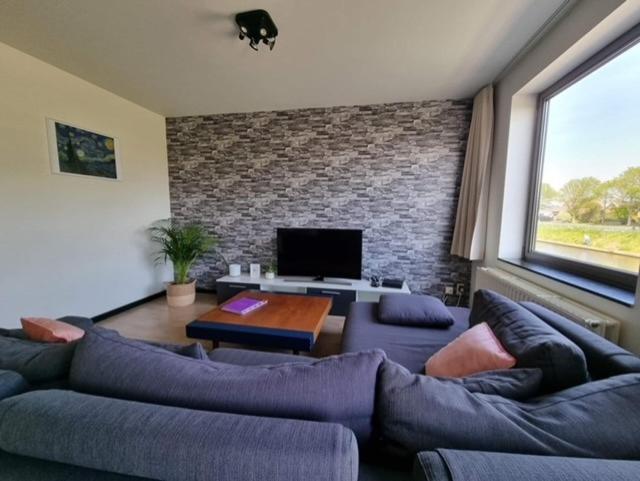 弗尔内Maison Noordburg Veurne的带沙发和电视的客厅
