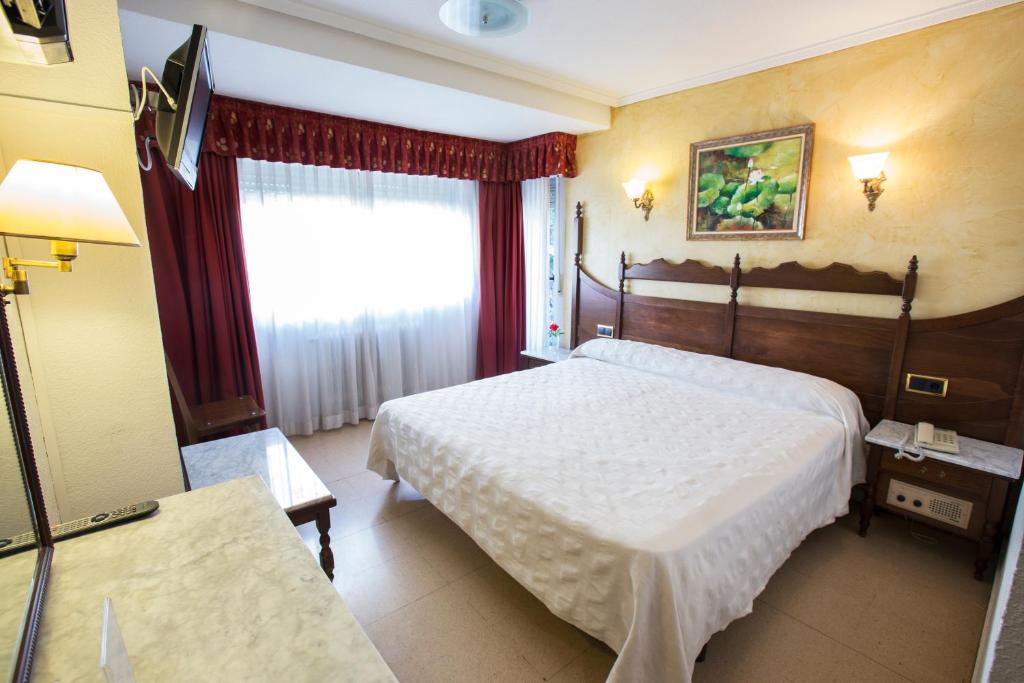 萨拉曼卡雷耶斯卡托里克斯酒店的酒店客房设有两张床和窗户。
