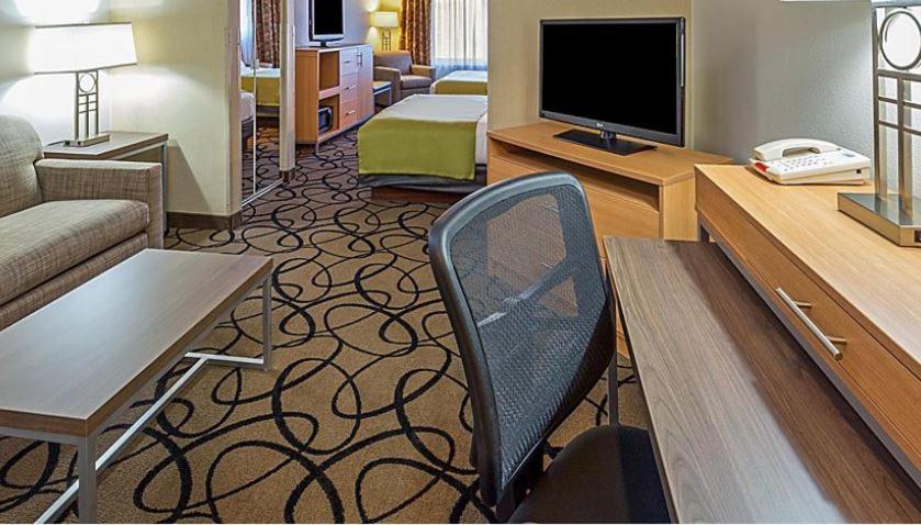 亨德森Holiday Inn Express & Suites - Henderson South - Boulder City, an IHG Hotel的一间客厅,客厅配有沙发和椅子,位于酒店的房间