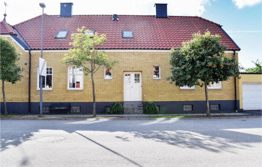 斯塔德Nice Apartment In Ystad With 2 Bedrooms And Wifi的黄色砖屋,有红色屋顶