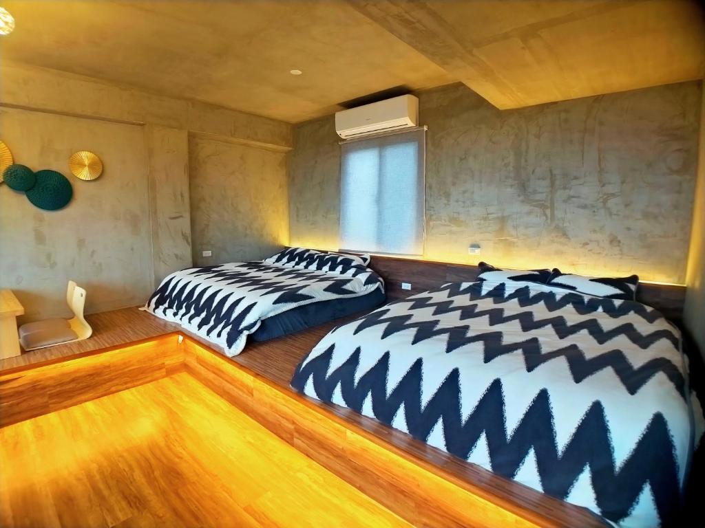 三芝乡海灣旅宿的两张睡床彼此相邻,位于一个房间里
