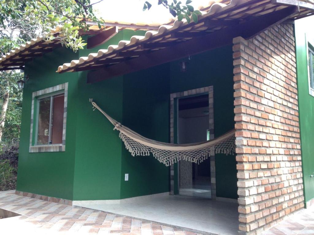 韦尔卡鲍Chalé Verde - Vale do Capão的外面带吊床的绿色房子