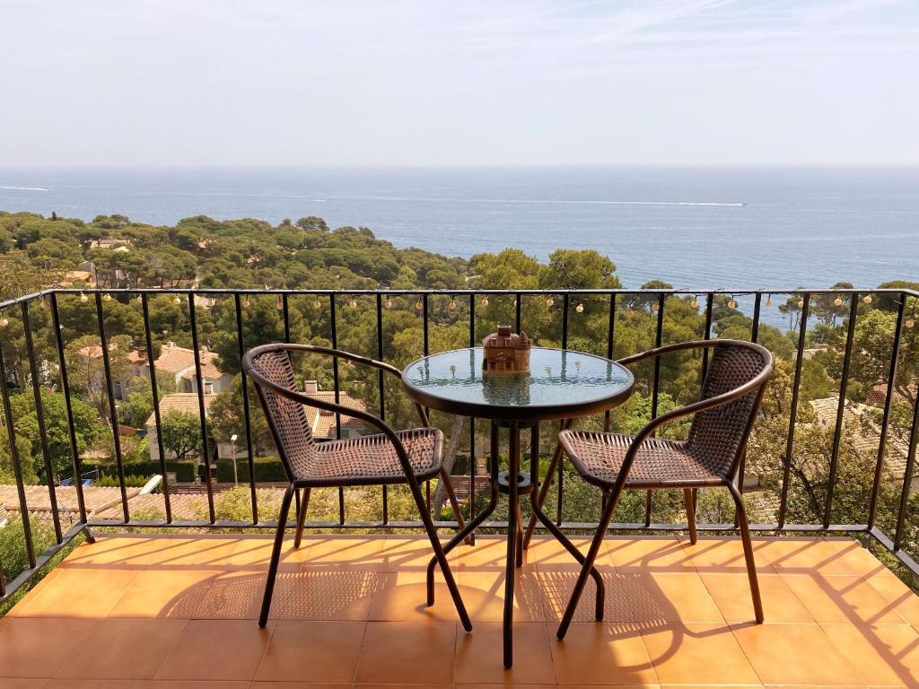 卡莱利亚德帕拉弗鲁赫尔Wonderful Apartment with Outstanding Views - Calella de Palfrugell的阳台配有一张桌子和两把椅子,享有海景