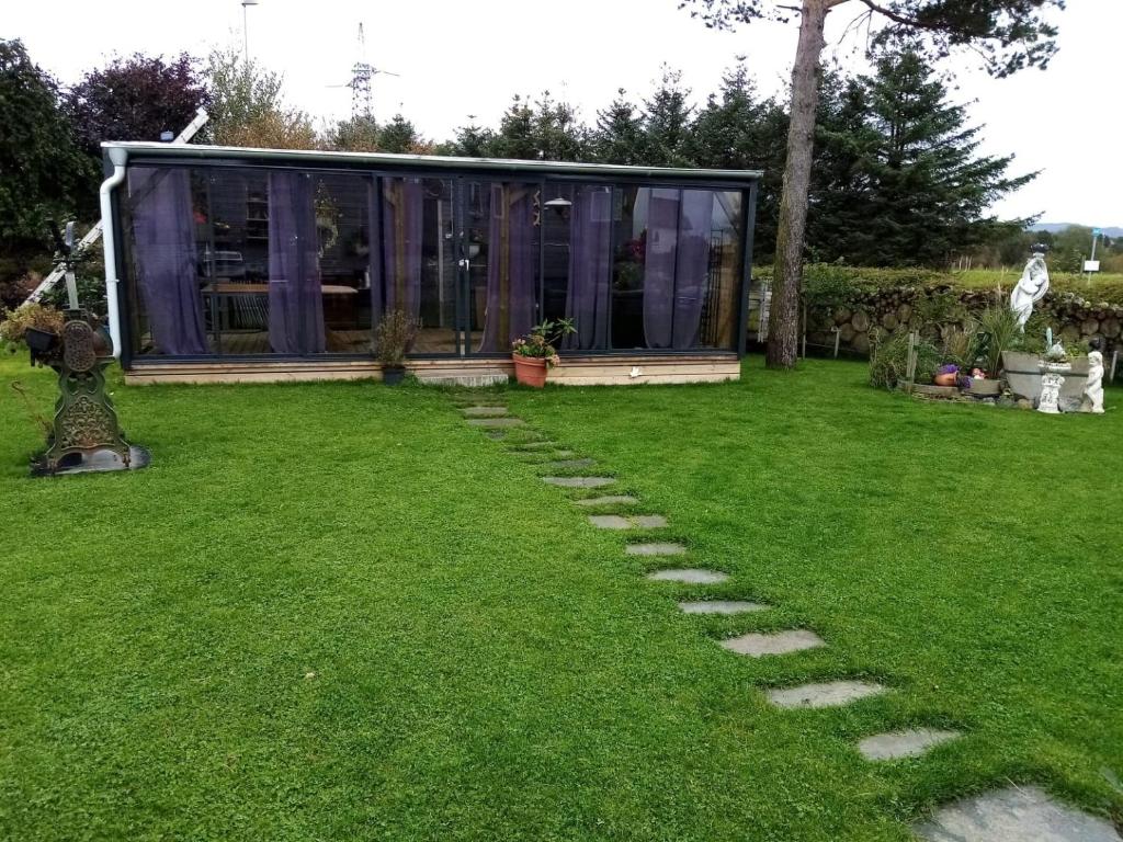 斯塔万格Garden Guest House Room with Terrace的草地上带玻璃屋的花园