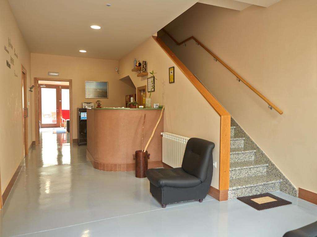 梅利德奥波谷佩雷罗旅舍的一间带椅子和楼梯的客厅
