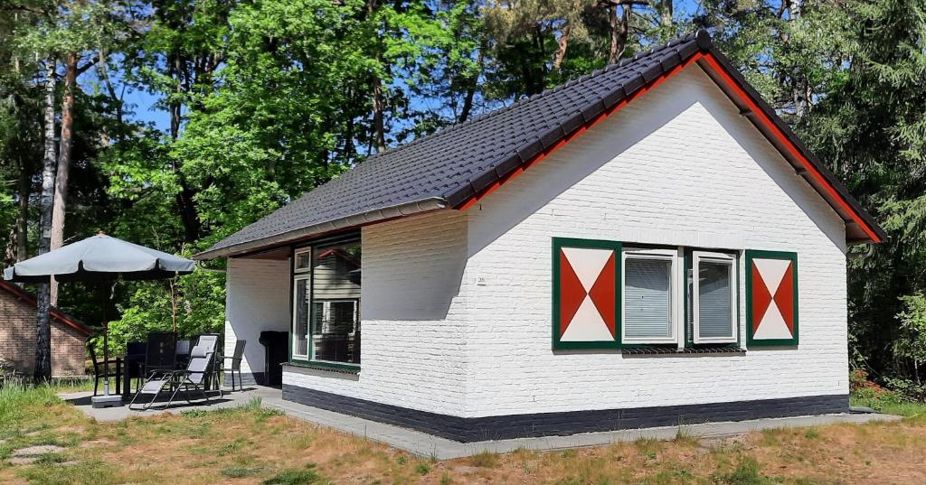 斯特兰普罗伊Bungalow, vrijstaand, het Vosseven nr 38的窗户上红色十字架上的白色小房子
