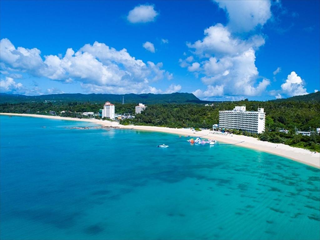 名户金秀喜瀬海滩宫殿酒店的享有海滩、建筑和大海的景色