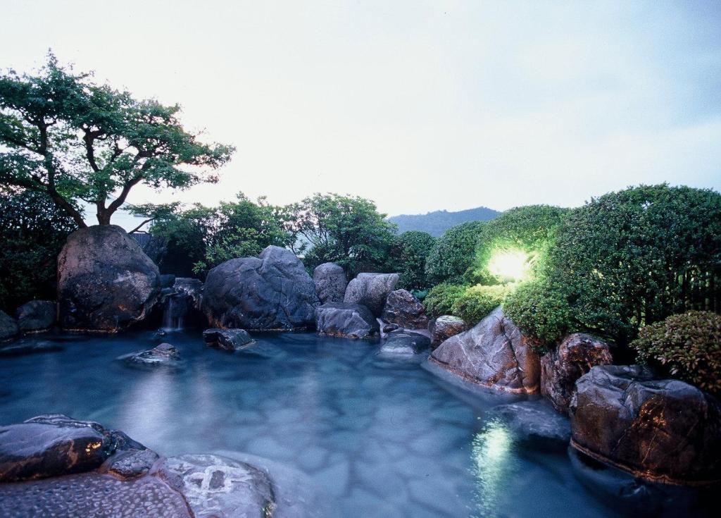 安来市鷺温泉酒店的一片种满岩石和树木的海水