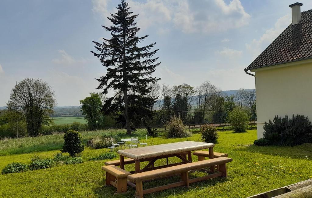 CarrougesGîte Cottage chaleureux en pleine campagne vue sur les Monts et Forêts et le château de Carrouges的树旁草上的野餐桌