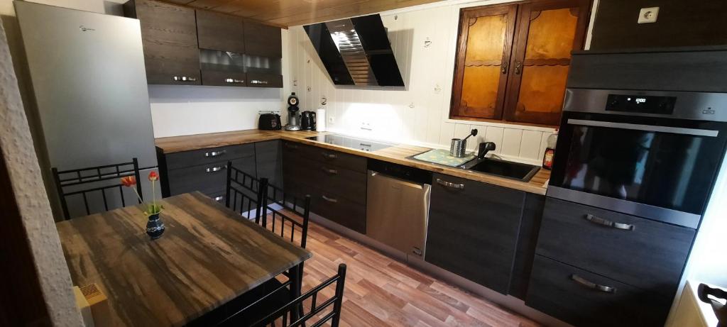 施卢赫湖Ferienwohnung Seelust的厨房铺有木地板,配有木桌。