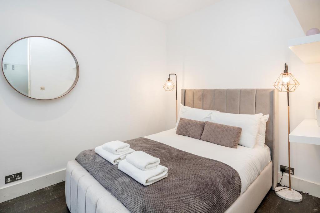 伦敦Beautiful 2 bedroom Covent Garden apartment的一间卧室配有一张大床和毛巾