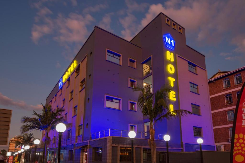 哈拉雷N1 Hotel Rotten Row Harare的建筑的侧面有 ⁇ 虹灯标志