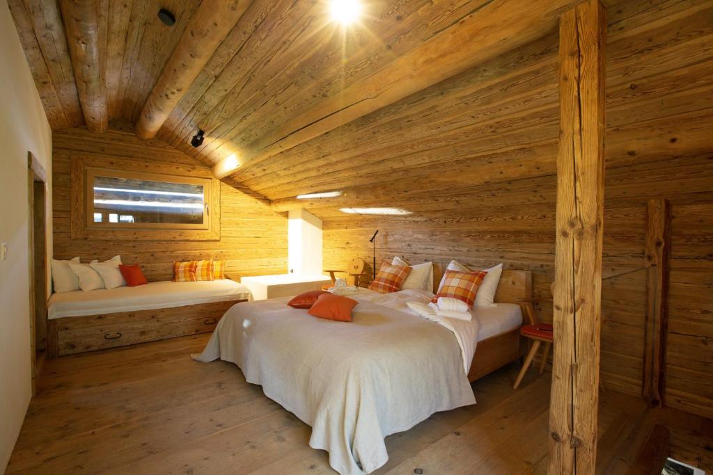ObervazMountain Cabin Tschividains Lenzerheide的小木屋内一间卧室,配有两张床
