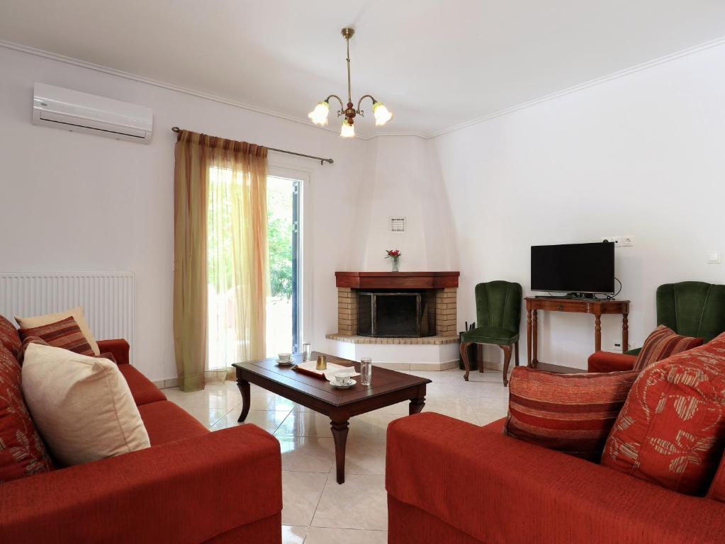 KariáFrida's House的客厅配有2张红色沙发和电视