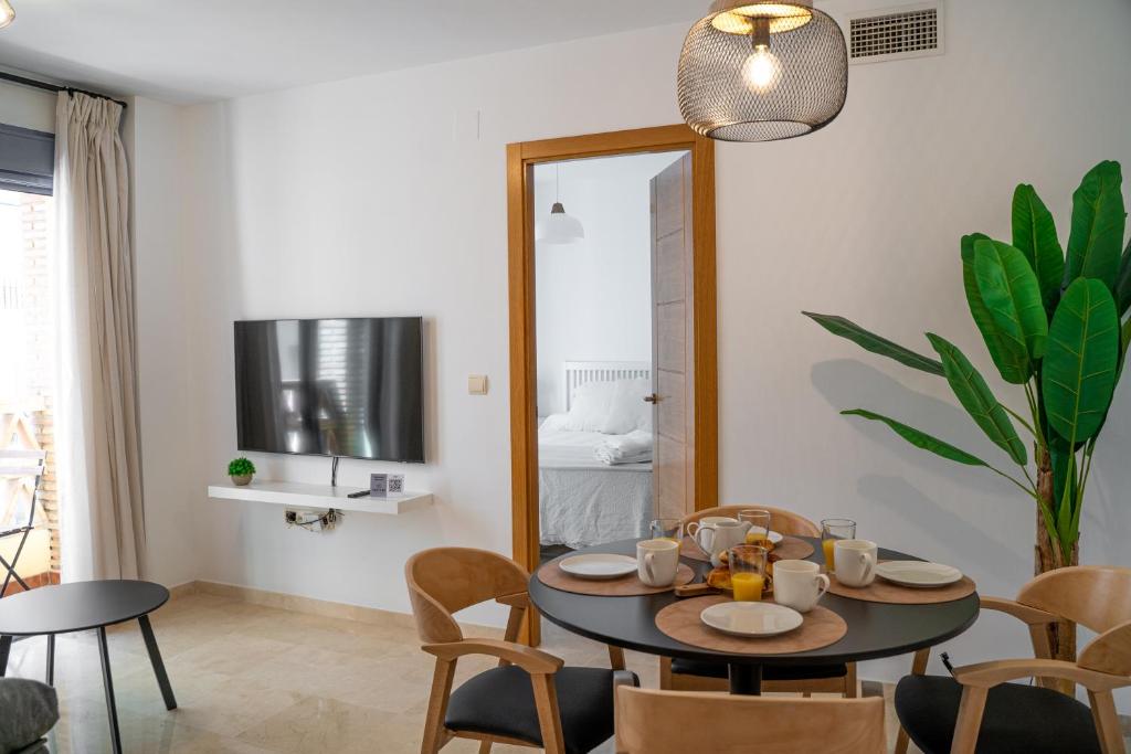 福恩吉罗拉Apartamento Puerto Playa, Fuengirola centro的一间带桌椅和镜子的用餐室