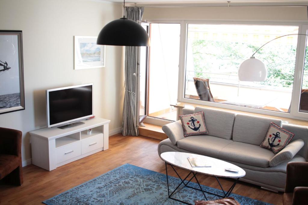 弗伦斯堡fewo1846 - EastSide - komfortables Apartment im 2 OG mit Balkon und TG-Stellplatz的带沙发和电视的客厅