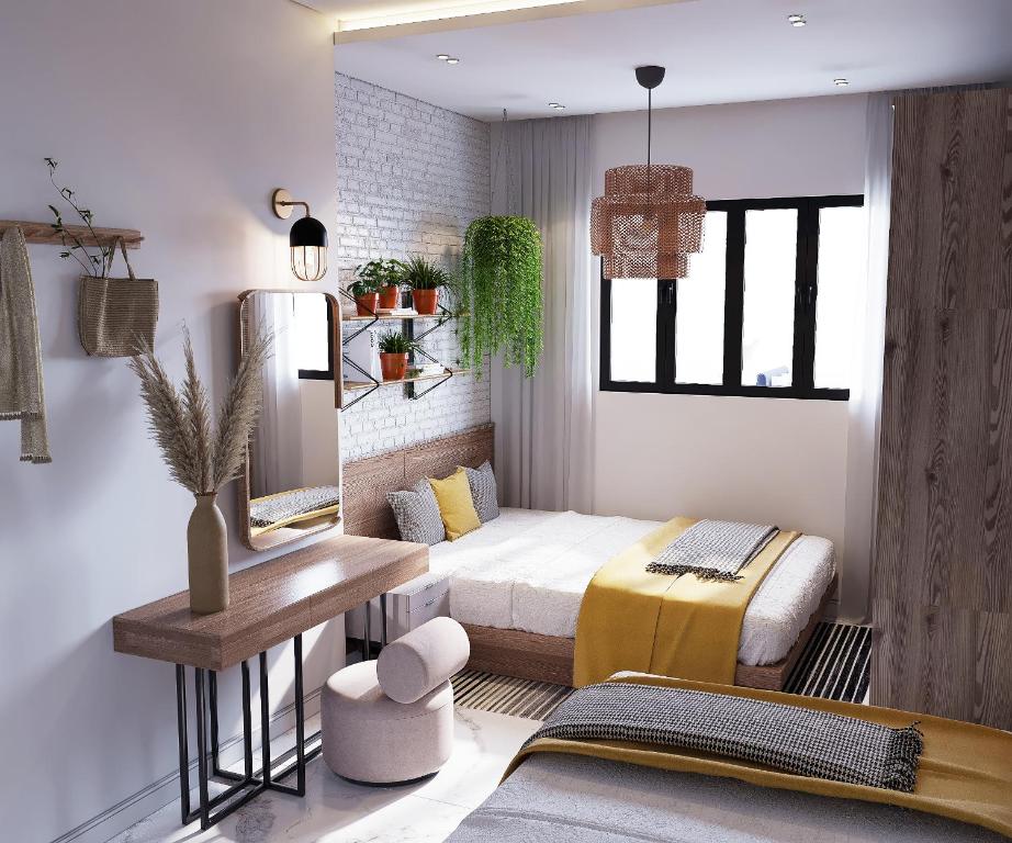 阿莱曼Marina Resort New Alamein By Seven Seasons的一间卧室配有一张床、一张桌子和一张桌子