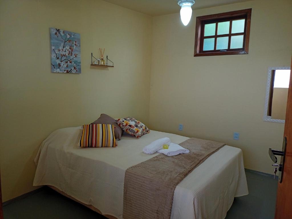巴哈古拉提巴Hostel Guaratiba Casa do Café的一间卧室配有一张床,上面有两条毛巾