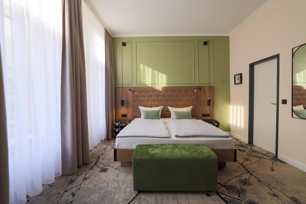 吕贝克LIHO - einfach Lübeck的一间卧室设有一张床和绿色的墙壁