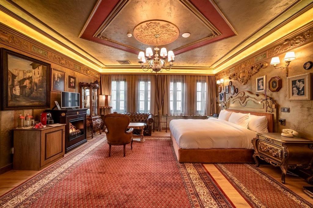 大特尔诺沃Bey House Royal Hotel的一间卧室配有一张床和一个吊灯