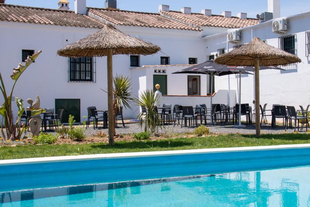 博尔诺斯Hacienda la Divertida的一个带游泳池和遮阳伞的酒店