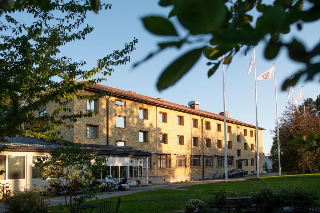 吕勒奥Sunderby folkhögskola Hotell & Konferens的前面有两面旗帜的建筑