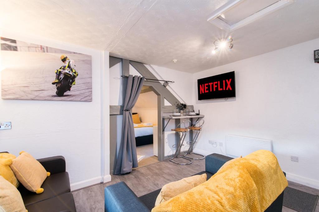 达宁顿堡DD Apartment 8 - Free Parking - Fast Wifi的客厅配有沙发和壁挂摩托车