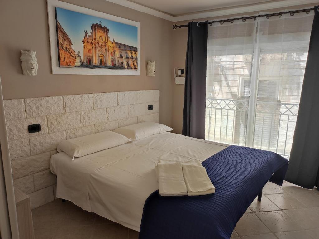 锡拉库扎Al Settimo porta marina的一间卧室设有一张大床和窗户