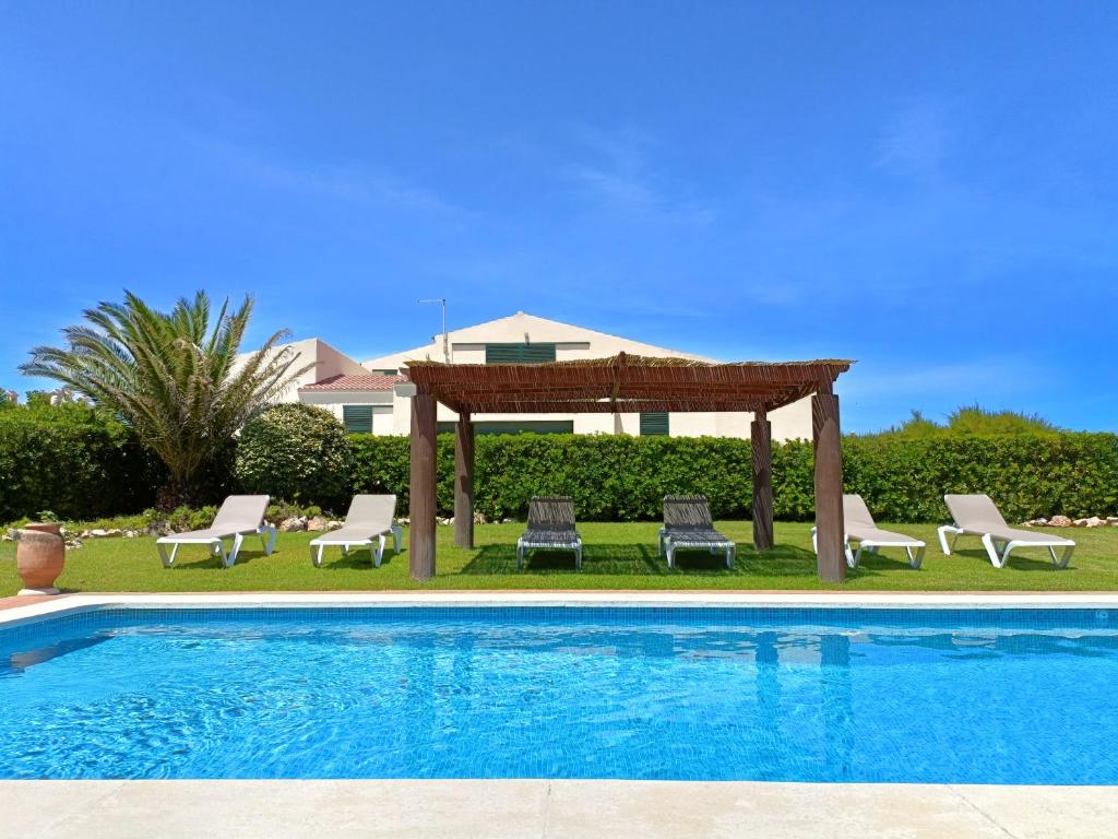 埃斯·梅卡达尔VILLA VEGA RELAX EN EL PARAISO的游泳池旁设有凉亭和椅子