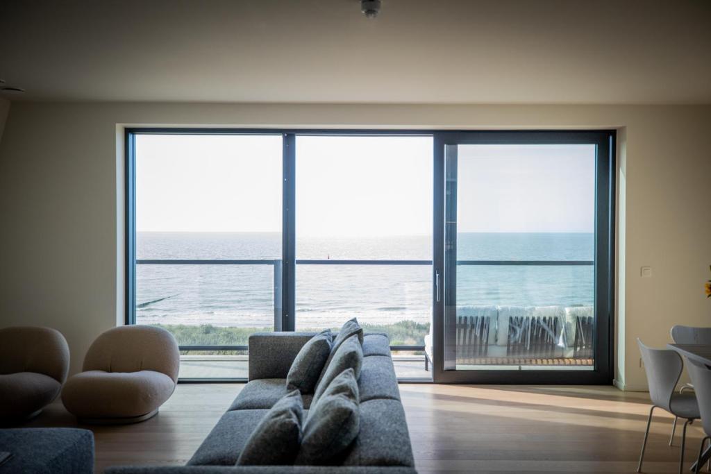 卡德赞德La Risacca, Luxurious, 3 bedroom, sea view design apartment的带沙发的客厅,享有海景