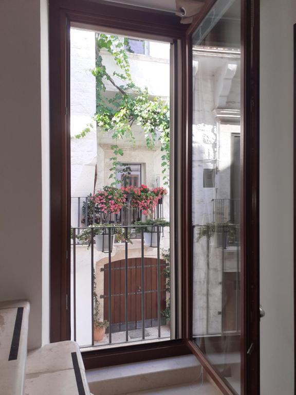 普蒂尼亚诺B&By in viaggio的窗户享有鲜花阳台的景致。