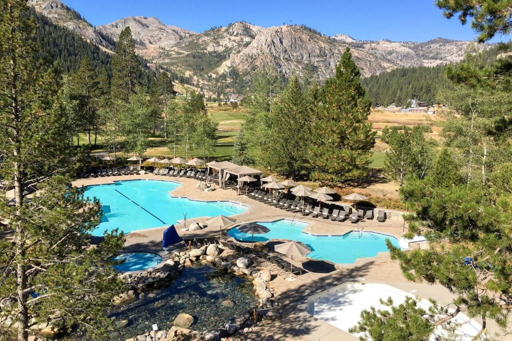 奥林匹克谷Resort at Squaw Creek II的享有度假村游泳池的空中景致,背景为山脉
