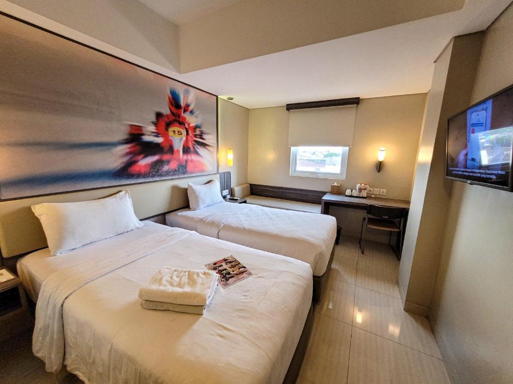日惹日惹考德迭拉卡德迪卡黛维酒店的酒店客房设有两张床和一台平面电视。