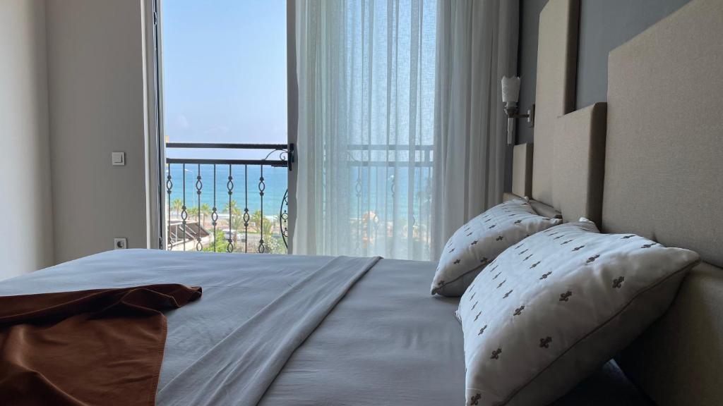 阿拉尼亚Green Garden City Luxury Apartments的一间卧室设有一张床,享有海景