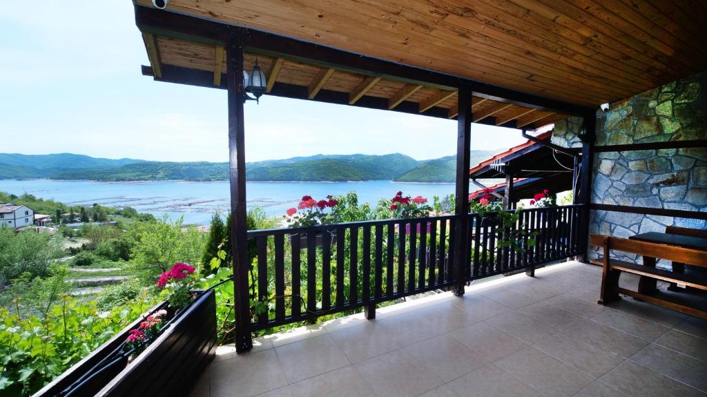 格拉瓦塔斯Penev guest house的阳台设有长凳,享有水景