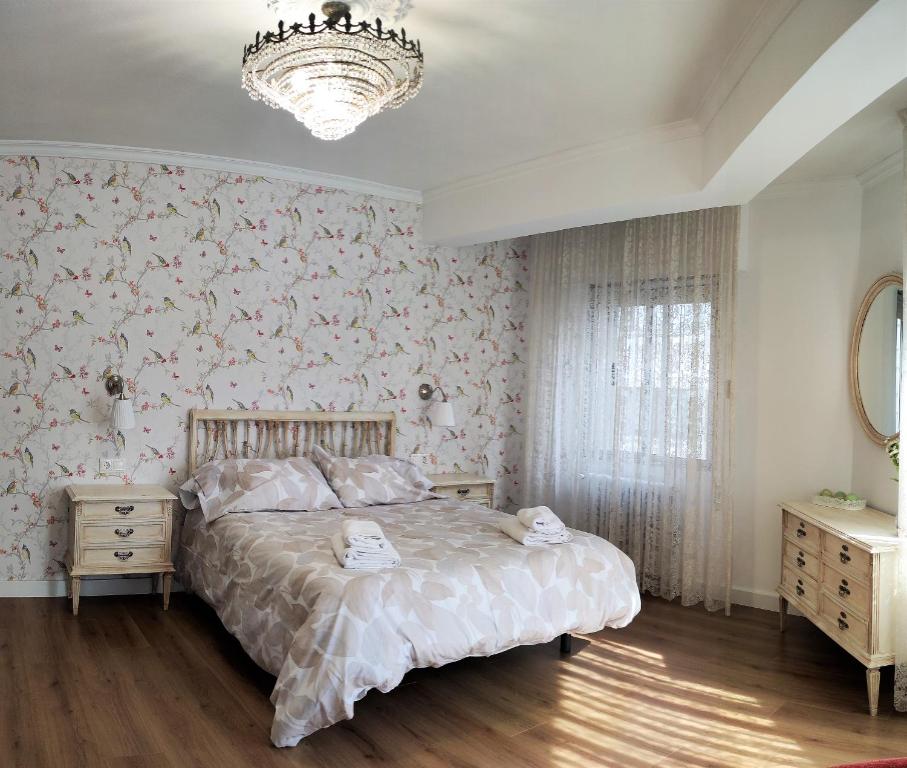 圣地亚哥－德孔波斯特拉CARMELA的一间卧室配有一张床和一个吊灯