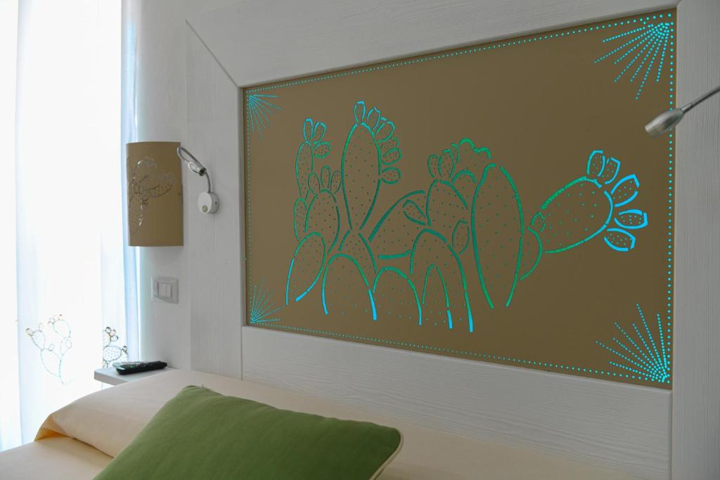 阿尔盖罗ALGHERO NOON的卧室墙上挂有植物画